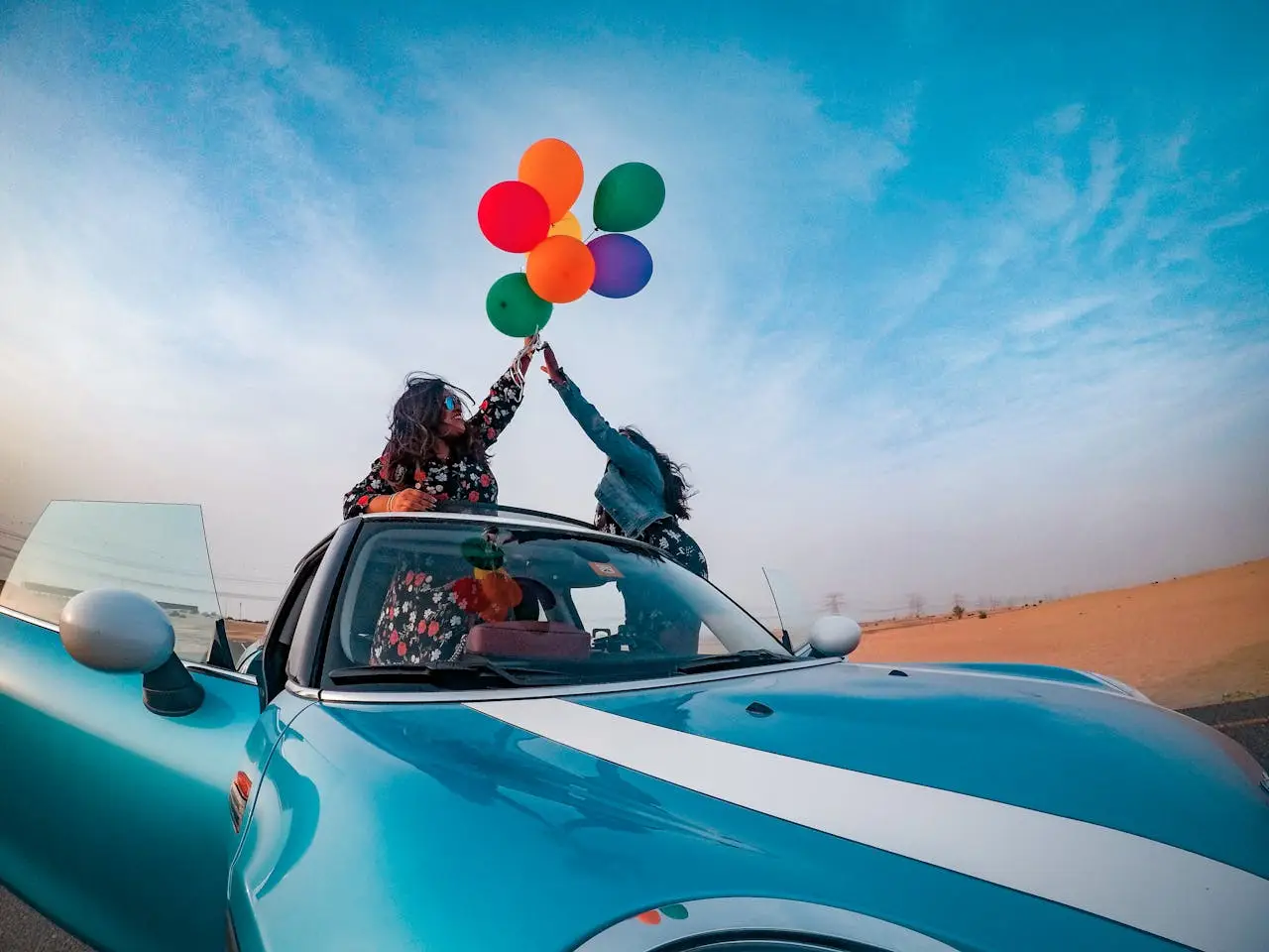 Two Women Holding Assorted-color Balloon Lot